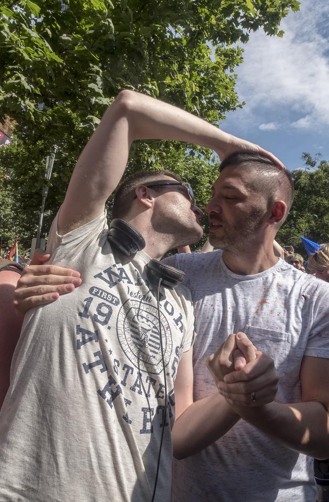 A couple celebrates the same-sex marriage postal survey Yes result in front of the State library of Victoria in Melbourne, Wednesday, November 15, 2017. Picture: AAP Image/Luis Enrique Ascui