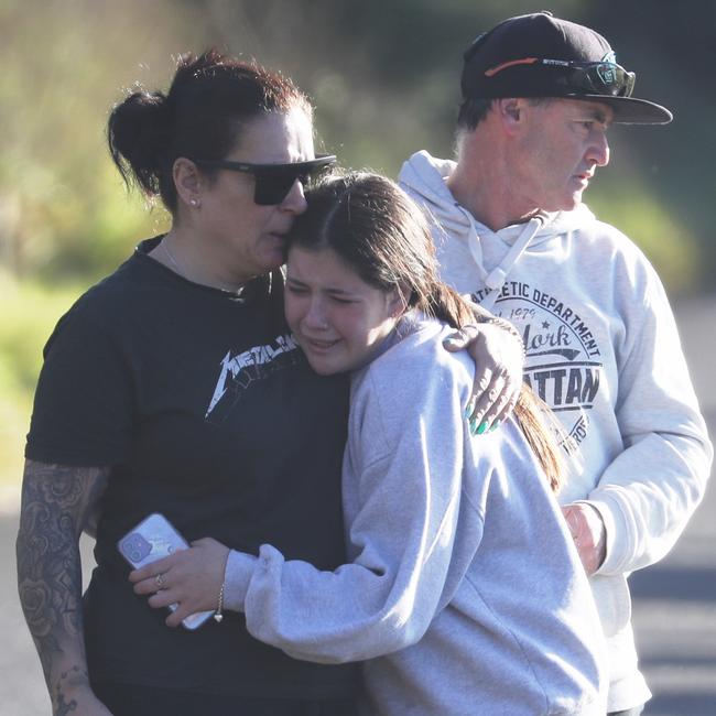 A young girl is comforted at the crash site today. Picture: John Grainger