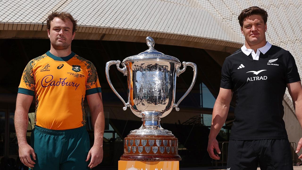 Wallabies captain Harry Wilson and All Blacks captain Scott Barrett pose alongside the Bledisloe Cup in Sydney. (Photo by Jason McCawley/Getty Images)