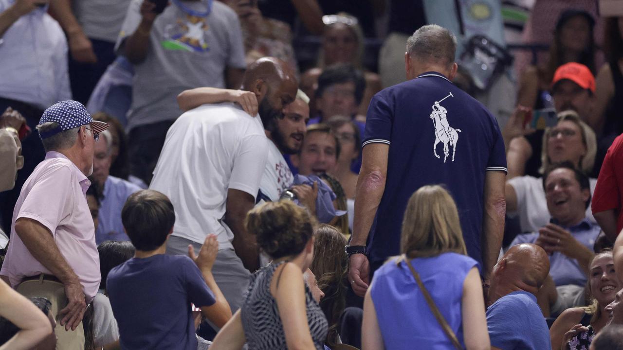 Environmental protestors wearing "End Fossil Fuel" t-shirts are escorted out. Photo by kena betancur / AFP.