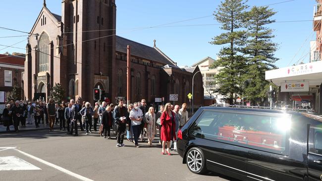 The funeral procession leaves St Matthews Anglican Church in Manly on Wednesday after the funeral of Australian surfing pioneer Barry Bennett. Picture: Tim Hunter.