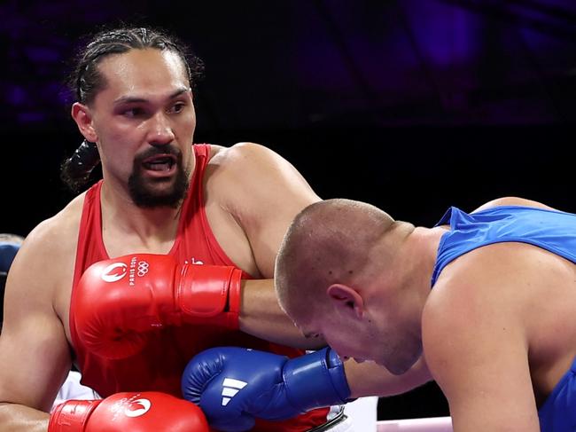 PARIS, FRANCE - JULY 29: Dmytro Lovchynskyi of Team Ukraine punches Teremoana Teremoana of Team Australia during the Men's +92kg preliminary round match between Teremoana Teremoana of Team Australia and Dmytro Lovchynskyi of Team Ukraine on day three of the Olympic Games Paris 2024 at North Paris Arena on July 29, 2024 in Paris, France. (Photo by Richard Pelham/Getty Images)