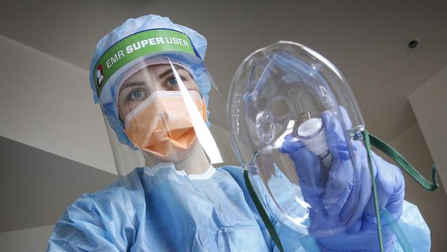 Royal Melbourne Hospital ICU nurse Laura Keily with a life saving oxygen mask. Picture: David Caird