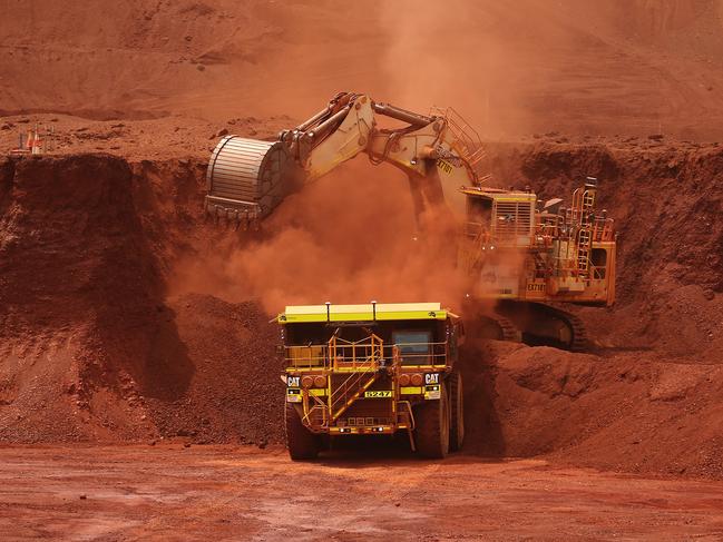 An excavator loads ore into an autonomous dump truck at Fortescue Metals Group Ltd.'s Solomon Hub mining operations in the Pilbara region, Australia, on Thursday, Oct. 27, 2016. Shares in Fortescue, the world's No. 4 iron ore exporter, have almost trebled in 2016 as iron ore recovered, and the company cut costs and repaid debt. Photographer: Brendon Thorne/Bloomberg via Getty Images