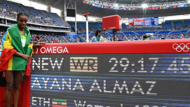 Ethiopia's Almaz Ayana celebrates next to a board displaying her new world record. Picture: AFP