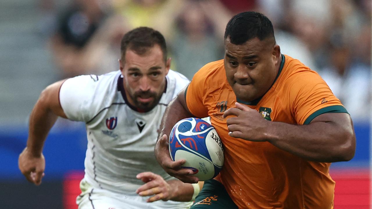 Australia's tighthead prop Taniela Tupou (R) runs with the ball during the France 2023 Rugby World Cup Pool C match between Australia and Georgia at Stade de France in Saint-Denis, on the outskirts of Paris, on September 9, 2023. (Photo by FRANCK FIFE / AFP)