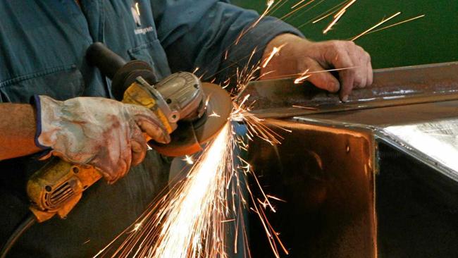 Sparks fly as a sheet metal worker fabricates a piece of mining equipment at Mastermyne Engineering.   Photo: Chris Ison / The Morning Bulletin. Picture: Chris Ison ROK270613cengineer9