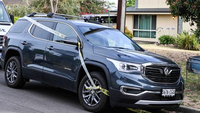 A car outside the Wark Court property was cordoned off with police crime scene tape. Picture: Brenton Edwards