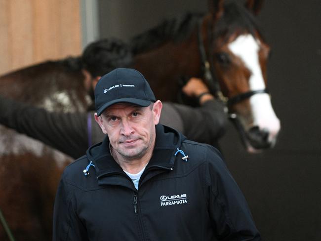 MELBOURNE, AUSTRALIA - OCTOBER 17: Chris Waller, trainer of Soulcombe (behind) after gallops at Caulfield Racecourse on October 17, 2023 in Melbourne, Australia. (Photo by Vince Caligiuri/Getty Images)