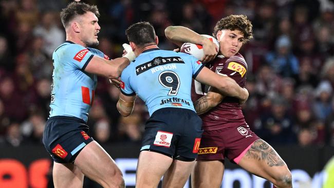 Reece Walsh of the Maroons is tackled by Reece Robson of the Blues during game three of the 2024 Men's State of Origin series between Queensland Maroons and New South Wales Blues at Suncorp Stadium on July 17, 2024 in Brisbane, Australia. (Photo by Bradley Kanaris/Getty Images)