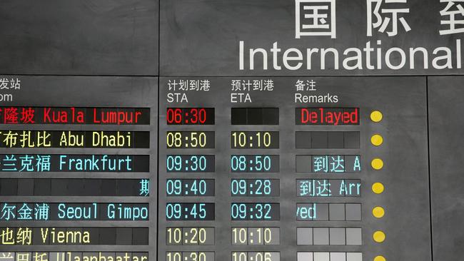 The arrival board at the International Airport in Beijing shows flight MH370 as delayed after air traffic control lost contact with the plane. Picture: AP