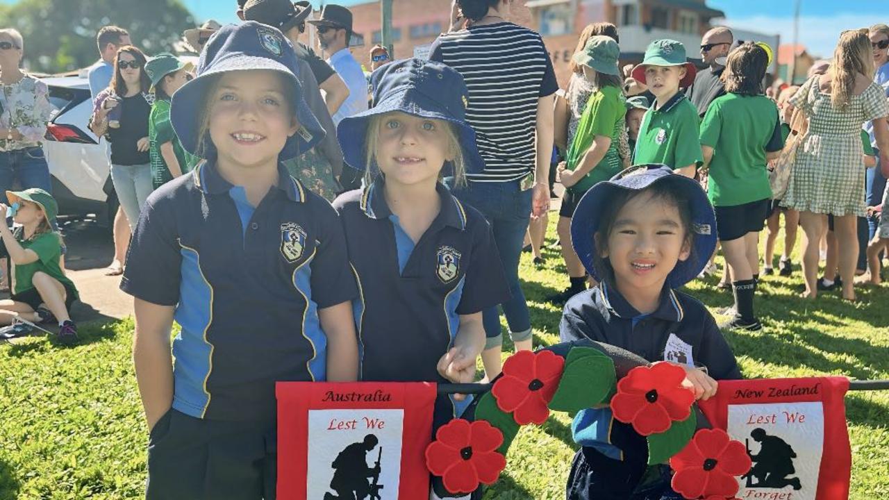 Children from St Patrick's primary proudly holding a wreath.