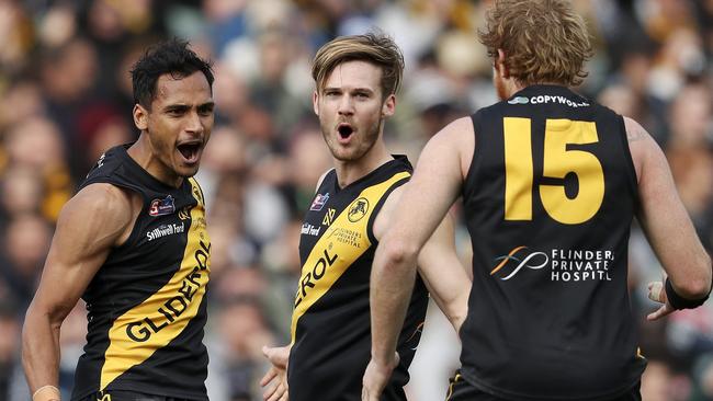 Marlon Motlop celebrates one of his goals with Glenelg teammates Jonty Scharenberg and Joshua Scott. Picture SARAH REED