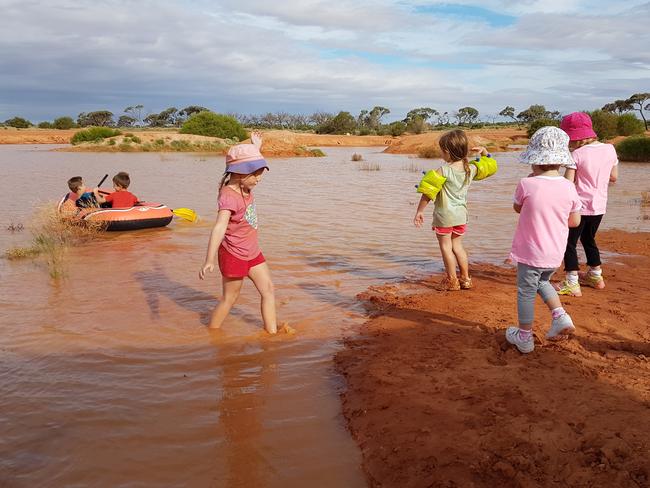 Keeping cool ... Caden and Max Simmons take the boat, Skyelah Petty walks in water and Malis Petty, Zoe McInnis and Simone McInnis are on the side.