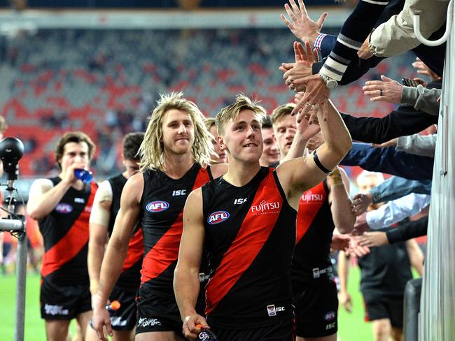 GOLD COAST, AUSTRALIA - AUGUST 19:  Joshua Begley of the Bombers celebrates victory with fans after the round 22 AFL match between the Gold Coast Suns and the Essendon Bombers at Metricon Stadium on August 19, 2017 in Gold Coast, Australia.  (Photo by Bradley Kanaris/Getty Images)