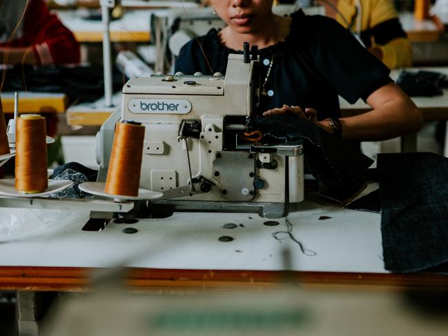 A local seamstress works on Outland Denim jeans in Cambodia. Pic: Amy Higg.