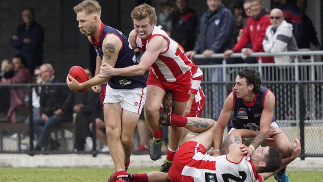 SFNL: Drew Stockton of Springvale Districts attempts to handball. Picture: Valeriu Campan