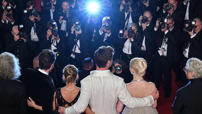 (from L) Australian producer Doug Mitchell, British actor Tom Burke, Spanish actress Elsa Pataky, Australian actor Chris Hemsworth, British-US actress Anya Taylor-Joy, Australian director and screenwriter George Miller pose as they leave after the screening of the film "Furiosa: A Mad Max Saga" at the 77th edition of the Cannes Film Festival in Cannes, southern France, on May 15, 2024. (Photo by Antonin THUILLIER / AFP)