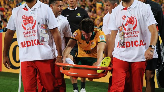 Australia's Robbie Kruse is carried from the pitch after being injured during the Asian Cup Final between Australia and Korea Republic at Stadium Australia, Homebush. Picture: Toby Zerna