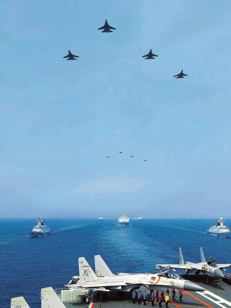 A formation of J-15 “Flying Shark” fighters fly over the aircraft carrier Liaoning during a fleet review attended by Chairman Xi Jinping in 2018. Picture: mod.gov.cn/PLA