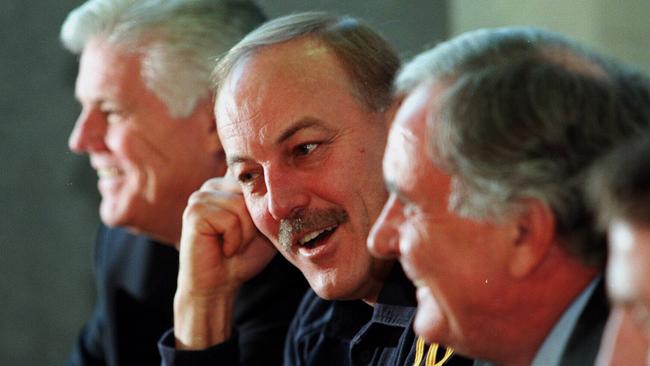 The Crows hierarchy can still manage a smile, as Malcolm Blight announces his resignation as Adelaide coach in 1999. Picture: Russell Millard