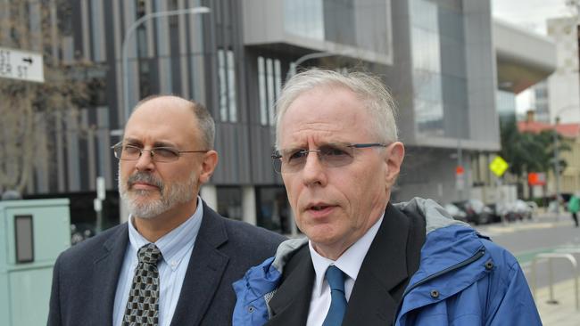 Royal Adelaide Hospital acting head of radiology, Dr Jim Buckley (right), leaves the Coroners Court last week.