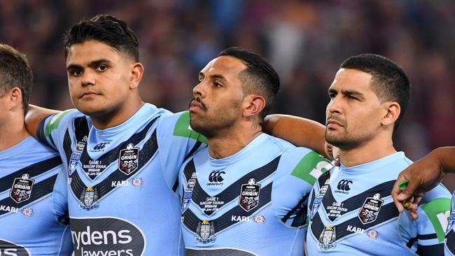 Latrell Mitchell (l to r) Josh Addo-Carr and Cody Walker stay silent during the national anthem at the start of Game 1 of the 2019 State of Origin series. Picture: AAP