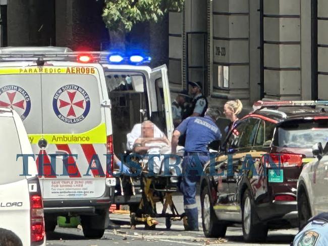 28/02/2024: A male victim is loaded into an ambulance as officers from Sydney City Police Area Command attended and found a man believed to be suffering a gunshot wound in Sydney's CBD. A man has been arrested and there is no further ongoing threat to the community. Picture: The Australian