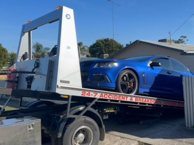 A Holden vehicle being seized as part of police investigation into a Holden Special Vehicles rebirthing ring.