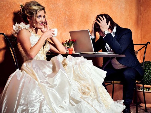 Beautiful bride drinking coffee and groom in shock seeing how much money he has spent for the wedding. Initial Rating 5! Thak you, iStock :-)