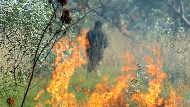 Rangers burning off scrub in the traditional way in the Northern Territory. Northern Beaches Council is looking at integrating Indigenous practices into its fire management policy. Picture: Supplied