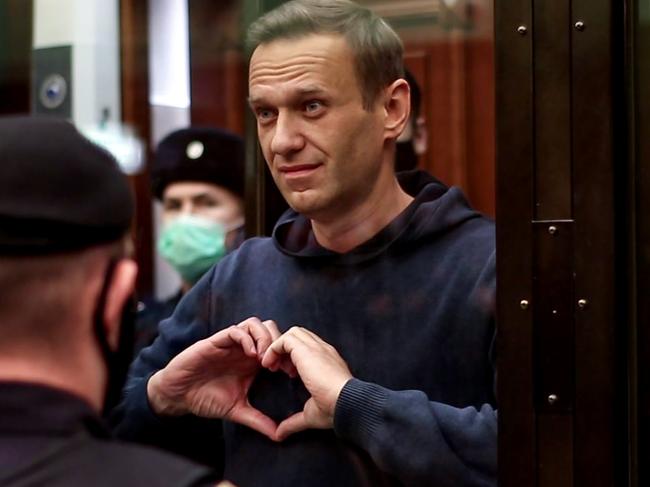 Russian opposition leader Alexei Navalny gesturing a heart shape from inside a glass cell during a court hearing in Moscow on February 2, 2021. Picture: AFP