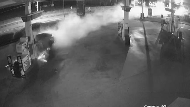 Smoke rises from the bowser as the car slams into the petrol station in December.