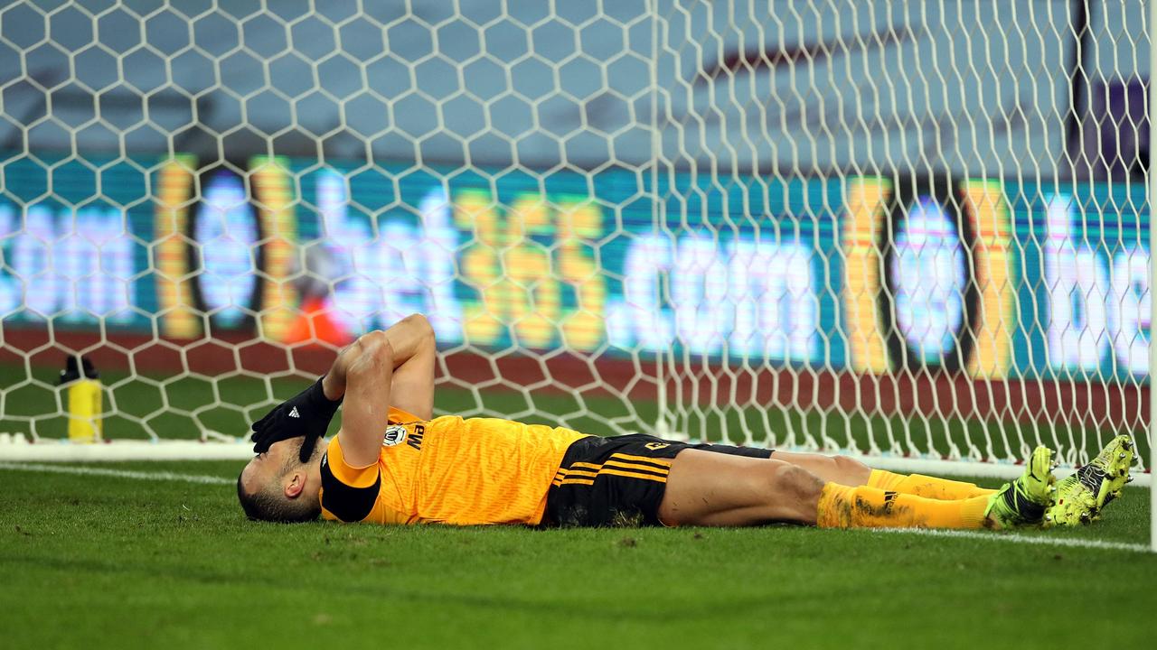 Wolverhampton Wanderers' Romain Saiss reacts after failing to score at close range. (Photo by PETER CZIBORRA / POOL / AFP)