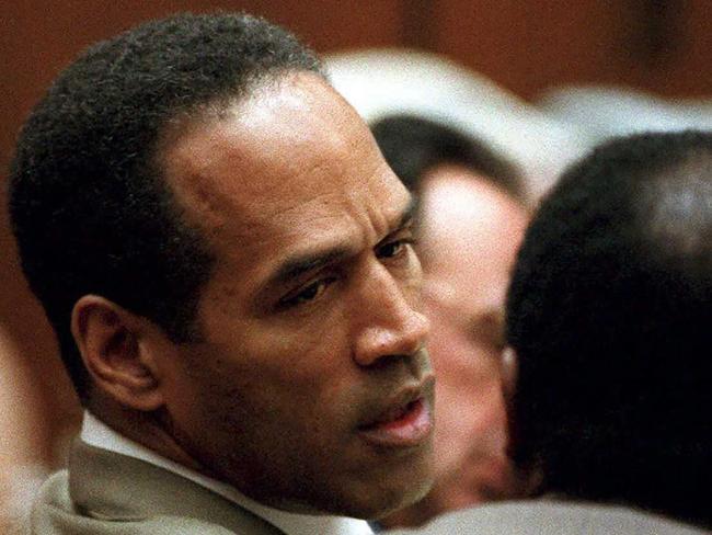 OJ Simpson talks to his lawyer during his 1995 trial for the murders of his wife, Nicole Brown Simpson, and her friend, Ron Goldman. Picture: AFP