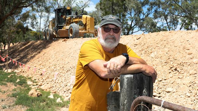 Cobdogla Caravan Park resident Ric Wenske in front of the levee around the town and caravan park. Picture Dean Martin