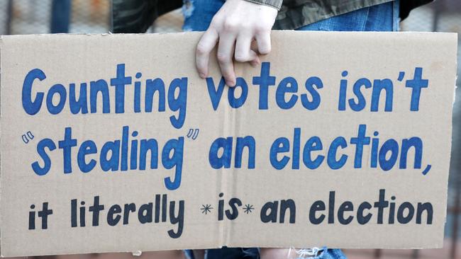 A protester carries a sign in Detroit, Michigan.