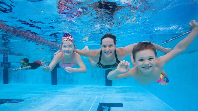 Former Olympic gold medallist Susie O'Neill with junior swim squad members Georgia Cooke, 7, and Arthur Joseph, 5, at Yeronga Park Swimming Pool. Picture by Luke Marsden.