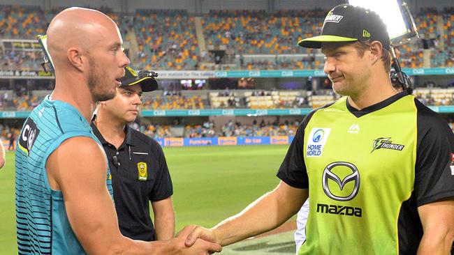 Brisbane Heat captain Chris Lynn (left) and Sydney Thunder captain Shane Watson shake hands after their BBL clash was abandoned on Thursday night. 