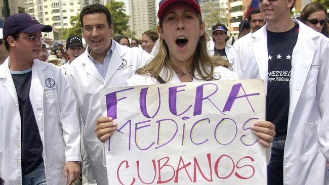 ‘Out Cuban doctors’: A Venezuelan doctor protests in Caracas. Picture: AP