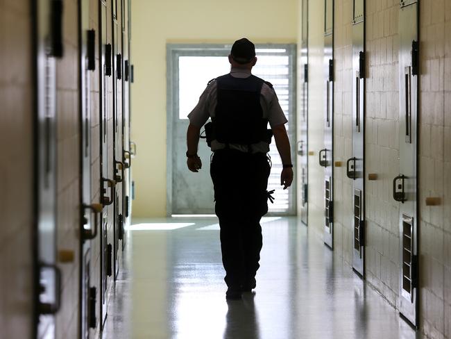 A corrections officer walks down a cell corridor. Prison stock at Borallon Correctional Centre, in Brisbane, Tuesday July 3, 2018. (AAP Image/Jono Searle) NO ARCHIVING