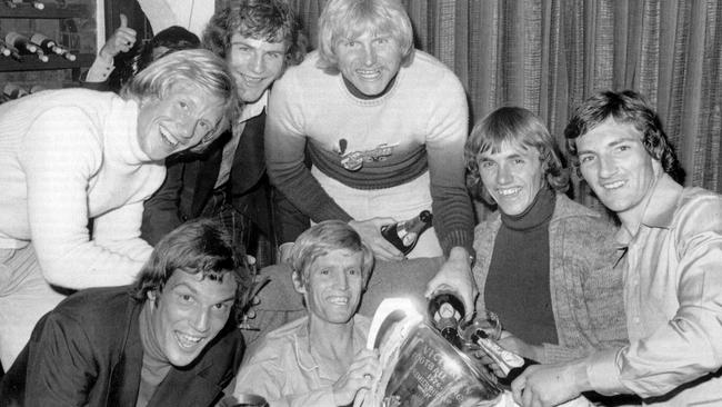 Bernie Jones, Brian Douge, Ian Bremner, Alan Martello, Peter Knights, Barry Rowlings, John Hendrie with Peter Crimmins (centre) and the 1976 premiership cup at his home. Picture: HWT