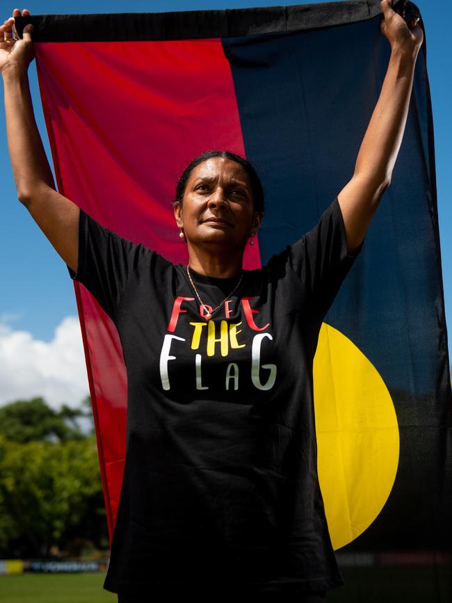 Nova Peris stands with the Aboriginal Flag. Picture: Che Chorley