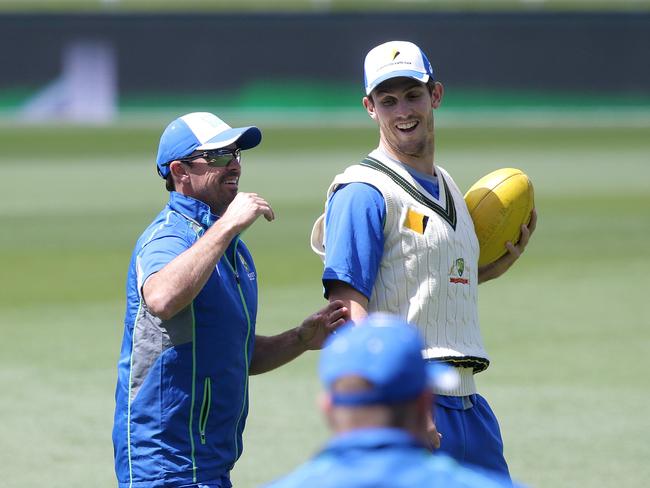 CRICKET: Wednesday 9th November 2016, Blundstone Arena: Australia’s Mitch Marsh (right) kicks the football with Australian coaching staff member Greg Blewett (left). Picture: LUKE BOWDEN