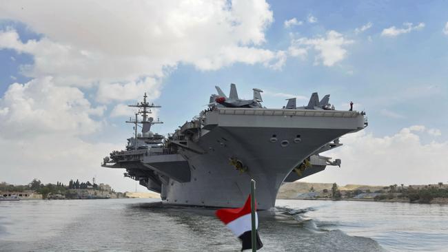 The USS Abraham Lincoln sails south in the Suez canal near Ismailia, Thursday, May 9, 2019. The White House said Wednesday it dispatched the aircraft carrier and B-52 bombers to the Persian Gulf over what it described as a new threat from Iran. (Suez Canal Authority via AP)