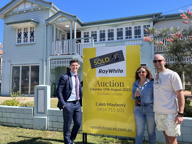 Property agent Caleb Mayberry from Ray White Ascot with new buyers at 12 Lanham Avenue, Grange.