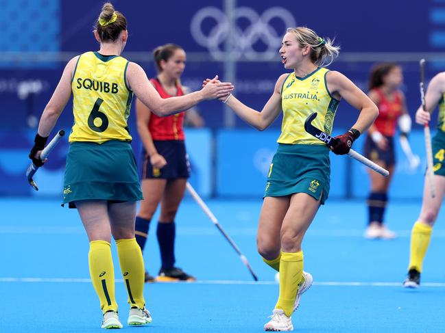 PARIS, FRANCE - AUGUST 03: Alice Arnott of Team Australia (R) celebrates scoring her team's first goal with teammate Penny Squibb during the Women's Pool B match between Australia and Spain on day eight of the Olympic Games Paris 2024 at Stade Yves Du Manoir on August 03, 2024 in Paris, France. (Photo by Lintao Zhang/Getty Images)