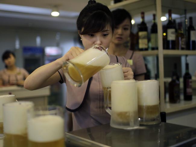 A waitress pours a new type of Taedonggang beer, the eighth in its line of specialty brews, made of wheat and hops at the Taedonggang Brewery in Pyongyang. Picture: Wong Maye-E/AP