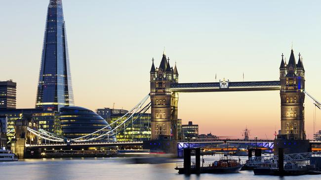 London's skyline with Tower Bridge, The Shard and City Hall at dusk.