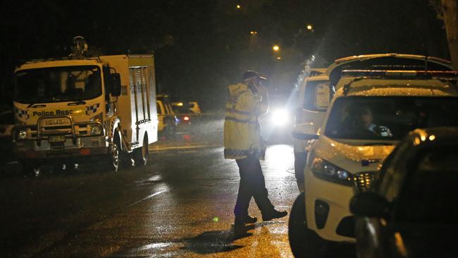 Multiple police remain at the scene of a shooting in Auburn on Monday night. Picture: Richard Dobson